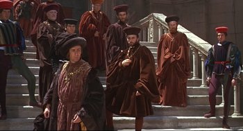 Movie still from “Romeo and Juliet” (1968), directed by Franco Zeffirelli – A group of men standing next to each other on some steps; Wide shot, High angle