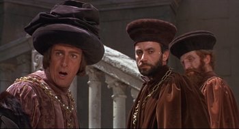 Movie still from “Romeo and Juliet” (1968), directed by Franco Zeffirelli – A group of men standing next to each other wearing hats; Medium shot, Low angle