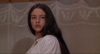 Movie still from “Romeo and Juliet” (1968), directed by Franco Zeffirelli – A woman with long black hair standing in front of a wall; Close Up shot, Low angle