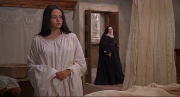 Movie still from “Romeo and Juliet” (1968), directed by Franco Zeffirelli – A woman standing in front of a nun in a room; Medium shot, High angle