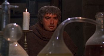 Movie still from “Romeo and Juliet” (1968), directed by Franco Zeffirelli – A man in a monk's robe looking at a candle; Close Up shot, Over the shoulder angle