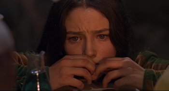 Movie still from “Romeo and Juliet” (1968), directed by Franco Zeffirelli – A person holding their hands to their face; Close Up shot, Over the shoulder angle
