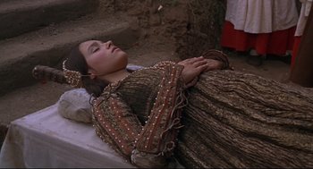 Movie still from “Romeo and Juliet” (1968), directed by Franco Zeffirelli – A woman in a dress laying on the ground; Medium shot, High angle