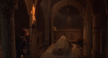 Movie still from “Romeo and Juliet” (1968), directed by Franco Zeffirelli – A man standing next to a fire in a room; Wide shot, High angle