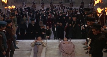 Movie still from “Romeo and Juliet” (1968), directed by Franco Zeffirelli – A group of people standing in front of a crowd; Wide shot, High angle