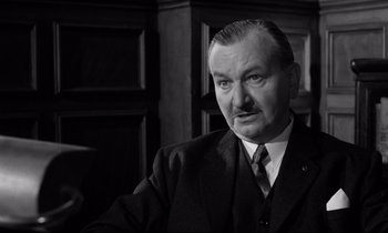 Movie still from “Room at the Top” (1958), directed by Jack Clayton – An older man in a suit and a tie; Close Up shot, Low angle