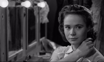 Movie still from “Room at the Top” (1958), directed by Jack Clayton – Black and white photograph of a woman in front of a mirror; Close Up shot, Over the shoulder angle