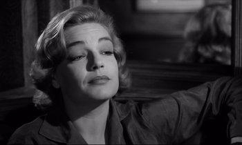 Movie still from “Room at the Top” (1958), directed by Jack Clayton – A black - and - white photo of a woman looking up at the sky; Close Up shot, Low angle