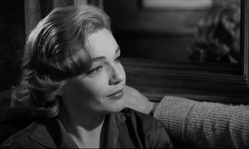 Movie still from “Room at the Top” (1958), directed by Jack Clayton – A black and white photo of a woman sitting on a couch; Close Up shot, Over the shoulder angle