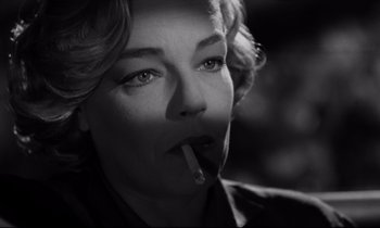 Movie still from “Room at the Top” (1958), directed by Jack Clayton – A black - and - white photo of a woman smoking a cigarette; Close Up shot, Low angle