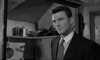 Movie still from “Room at the Top” (1958), directed by Jack Clayton – Black and white photograph of a man wearing a suit and tie; Close Up shot, Low angle