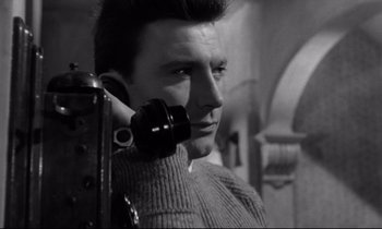 Movie still from “Room at the Top” (1958), directed by Jack Clayton – A black and white photo of a man holding a cell phone to his ear; Close Up shot, Low angle