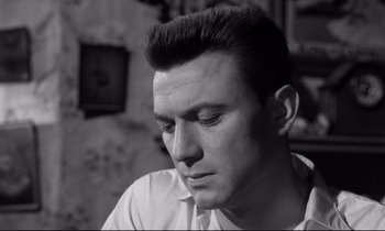 Movie still from “Room at the Top” (1958), directed by Jack Clayton – Black and white photograph of a man looking down; Close Up shot, Low angle
