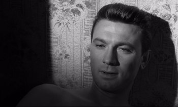 Movie still from “Room at the Top” (1958), directed by Jack Clayton – A black and white photo of a man's face; Close Up shot, Over the shoulder angle