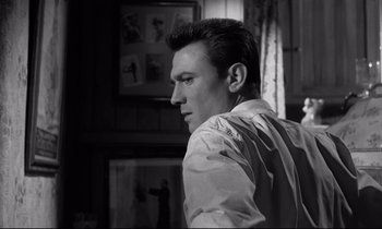 Movie still from “Room at the Top” (1958), directed by Jack Clayton – Black and white photograph of a man in a room; Close Up shot, Low angle