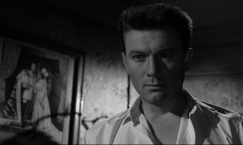 Movie still from “Room at the Top” (1958), directed by Jack Clayton – Black and white photograph of a man in a room; Close Up shot, Low angle