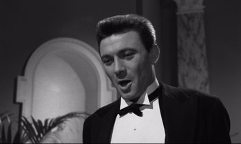Movie still from “Room at the Top” (1958), directed by Jack Clayton – A black and white photo of a man in a tuxedo; Close Up shot, Low angle