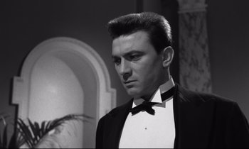 Movie still from “Room at the Top” (1958), directed by Jack Clayton – Black and white photograph of a man in a tuxedo; Close Up shot, Low angle