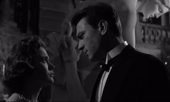 Movie still from “Room at the Top” (1958), directed by Jack Clayton – A man and a woman in tuxedos looking at each other; Close Up shot, Low angle