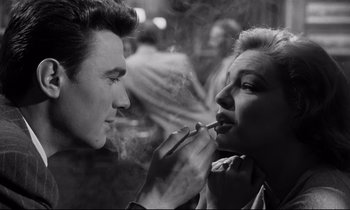 Movie still from “Room at the Top” (1958), directed by Jack Clayton – A man and a woman are smoking a cigarette together; Close Up shot, Over the shoulder angle