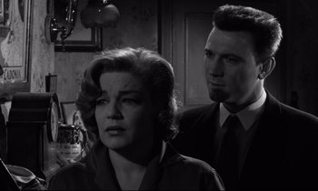 Movie still from “Room at the Top” (1958), directed by Jack Clayton – A man and a woman standing next to each other in a room; Close Up shot, Low angle