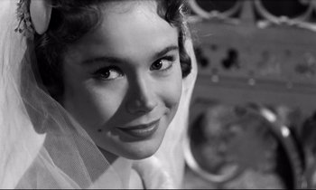 Movie still from “Room at the Top” (1958), directed by Jack Clayton – A black - and - white photo of a woman's face; Close Up shot, Over the shoulder angle