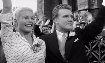 Movie still from “Room at the Top” (1958), directed by Jack Clayton – A black and white photo of a man and a woman; Medium shot, Low angle