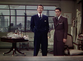 Movie still from “Rope” (1948), directed by Alfred Hitchcock – Two men standing next to each other in a room; Medium shot, Low angle