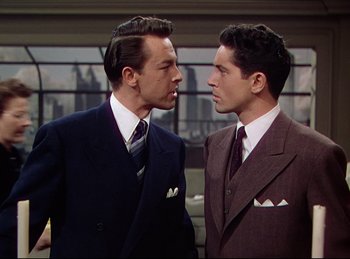 Movie still from “Rope” (1948), directed by Alfred Hitchcock – A couple of men standing next to each other; Medium shot, Over the shoulder angle