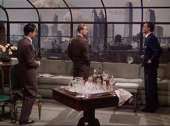 Movie still from “Rope” (1948), directed by Alfred Hitchcock – A group of men standing around in a room; Wide shot, High angle