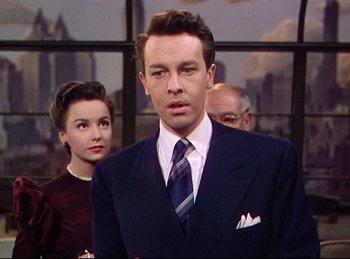 Movie still from “Rope” (1948), directed by Alfred Hitchcock – A man and two women standing in front of a window; Medium shot, Low angle