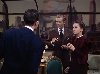 Movie still from “Rope” (1948), directed by Alfred Hitchcock – A man and a woman talking to a man in a suit and tie; Medium shot, Over the shoulder angle