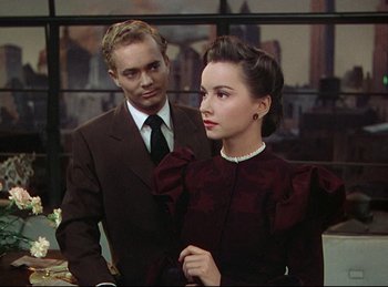 Movie still from “Rope” (1948), directed by Alfred Hitchcock – A man and a woman standing next to each other; Medium shot, Over the shoulder angle