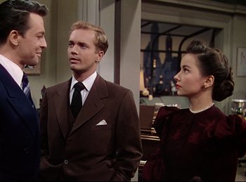 Movie still from “Rope” (1948), directed by Alfred Hitchcock – A man and two women standing next to each other; Medium shot, Over the shoulder angle