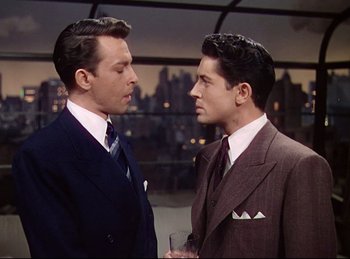 Movie still from “Rope” (1948), directed by Alfred Hitchcock – A couple of men standing next to each other; Medium shot, Over the shoulder angle