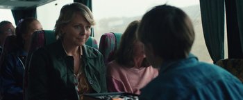 Movie still from “Rose” (2022), directed by Niels Arden Oplev – Three people are sitting on a bus together; Close Up shot, Over the shoulder angle