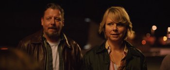 Movie still from “Rose” (2022), directed by Niels Arden Oplev – A man and a woman standing next to each other in the dark; Close Up shot, Low angle