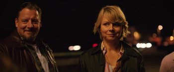 Movie still from “Rose” (2022), directed by Niels Arden Oplev – A woman standing next to another woman on a street; Close Up shot, Over the shoulder angle