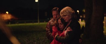 Movie still from “Rose” (2022), directed by Niels Arden Oplev – Two women and a man are standing in a field; Medium shot, Over the shoulder angle