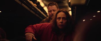 Movie still from “Rose” (2022), directed by Niels Arden Oplev – A man and a woman on a train; Medium shot, High angle