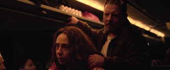 Movie still from “Rose” (2022), directed by Niels Arden Oplev – A man and a woman are combing each other's hair; Close Up shot, Over the shoulder angle