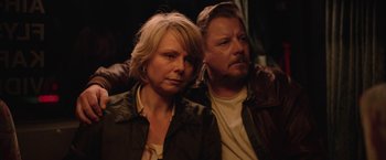 Movie still from “Rose” (2022), directed by Niels Arden Oplev – A man and a woman standing next to each other; Close Up shot, High angle