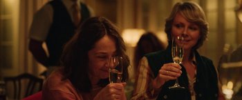 Movie still from “Rose” (2022), directed by Niels Arden Oplev – A woman holding a glass of wine in her hand; Close Up shot, Over the shoulder angle