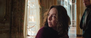 Movie still from “Rose” (2022), directed by Niels Arden Oplev – A person with long hair; Close Up shot, Over the shoulder angle