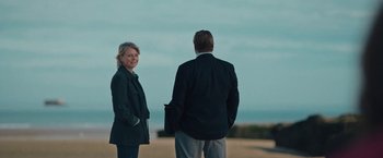 Movie still from “Rose” (2022), directed by Niels Arden Oplev – A man and a woman standing next to each other on the beach; Medium shot, Over the shoulder angle