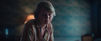 Movie still from “Rose” (2022), directed by Niels Arden Oplev – A woman with blonde hair wearing a striped shirt; Close Up shot, Low angle