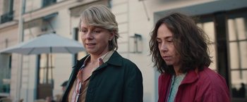 Movie still from “Rose” (2022), directed by Niels Arden Oplev – Two women standing next to each other on a sidewalk; Close Up shot, Low angle