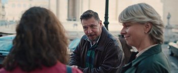 Movie still from “Rose” (2022), directed by Niels Arden Oplev – A group of people sitting around a table talking to each other; Close Up shot, Over the shoulder angle