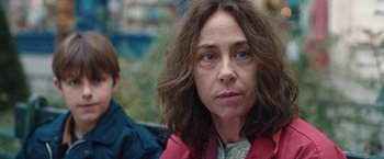 Movie still from “Rose” (2022), directed by Niels Arden Oplev – A person with long hair; Close Up shot, Over the shoulder angle