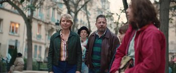 Movie still from “Rose” (2022), directed by Niels Arden Oplev – A group of people walking down a street; Medium shot, Over the shoulder angle